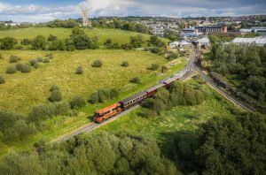 121 class loco 124 departs Downpatrick, with the iconic Downpatrick Cathedral in the background.