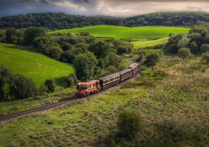 124 and its vintage train arrives at Inch Abbey under a moody sky.